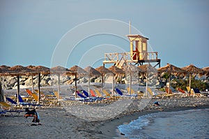 Empty beach with colorful sunbeds