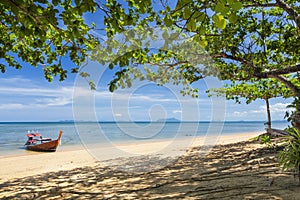 Empty beach with longtail boat on the island of Koh Libong, Thailand