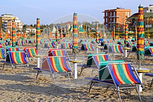 The empty beach with a lot of sunbeds and umbrellas.