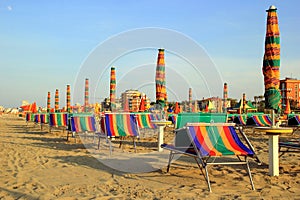 The empty beach with a lot of sunbeds and umbrellas.