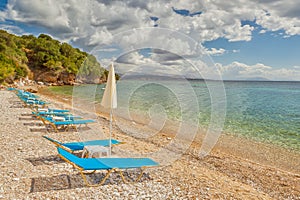 Empty beach Lounge chairs under bright sunlight