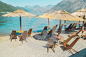 empty beach with sun loungers and umbrellas. sea with mountains
