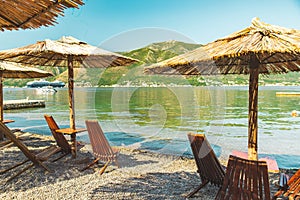 empty beach with sun loungers and umbrellas. sea with mountains