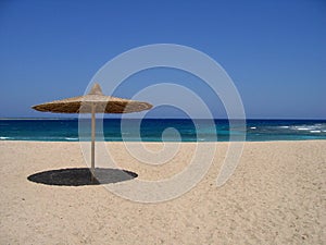 Empty beach with sunshade photo