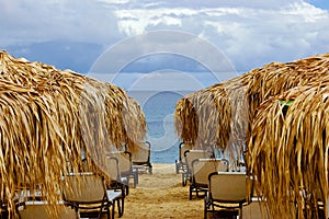 Empty beach with sunshades and chairs