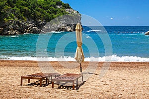 Empty beach with two chairs, Queen`s Beach, Montenegro