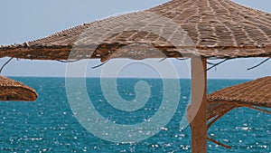 Empty Beach with Umbrellas in Egypt on the background of the Red Sea