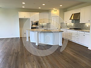 Empty Beautiful Modern White Kitchen with Wood Floors