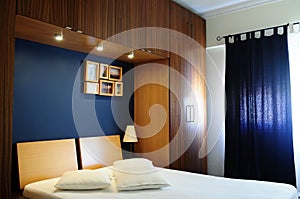 Empty Bed Room with Dark Navy Blue Wall and Wooden Wardrobe