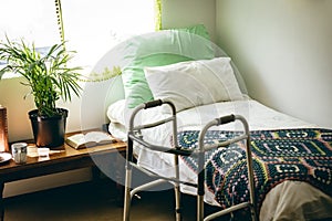 Empty bed and walker in bed room at retirement home