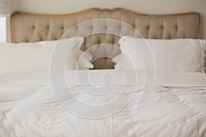 Empty bed with white duvet cover