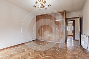 Empty bedroom with built-in wardrobe of four bodies and French