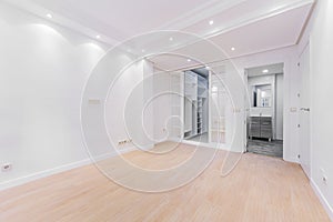 Empty bedroom with sliding doors to a dressing room and en-suite bathroom