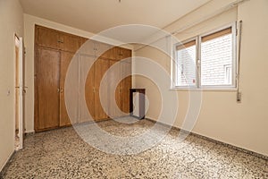 Empty bedroom stone floors, fitted wardrobes and chests