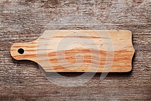 Empty beech cutting board with space for text on wood texture background