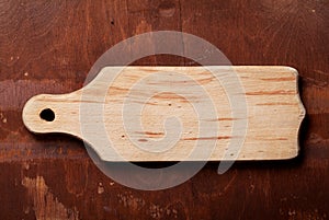 Empty beech cutting board with space for text on wood texture background