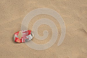 Empty beer can on the sand on the beach. Environmental pollution, ecology