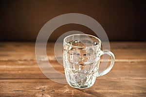 Empty beer glass close-up. Empty beer mug on a dark background and copy space