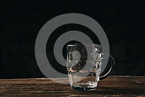 Empty beer glass mug on a wooden table