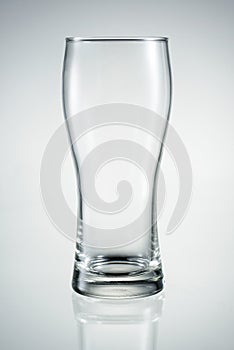 Empty beer glass with reflection isolated.