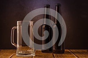 empty beer glass and two bottles/ empty beer glass and two bottles on a bar