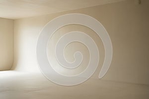 Empty beige studio corner with soft light background