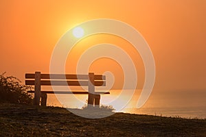 Empty bench with amazing sunrise sea view, peace and calm romantic travel background