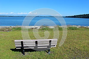 An empty bench with a beautiful bay view