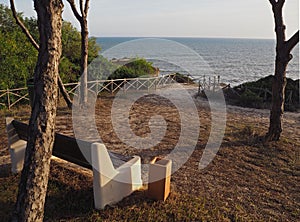 Empty bench on a beautiful sea wiew in golden evening light