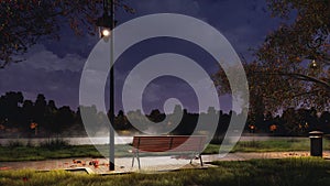 Empty bench in city park at dark autumn night