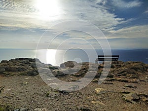 An empty bench on a cliff above the sea. Cape Greco view point near Ayia Napa. Travel, relaxation and tranquility.