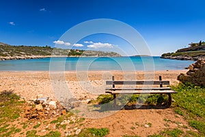 Empty bench at Marathi bay beach on Crete