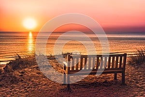 Empty bench near the beach at sunset on the island of Sylt photo