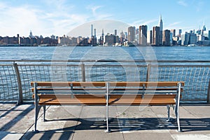 Empty Bench at a Park in Greenpoint Brooklyn New York looking out towards the East River and the Manhattan Skyline