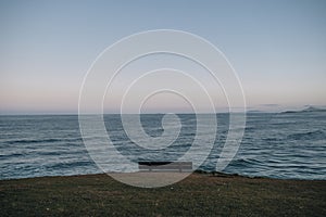 empty bench with peaceful ocean background