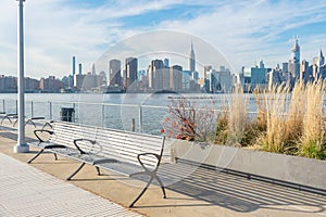 Empty Bench with Plants at a Park in Greenpoint Brooklyn New York looking out towards the East River and the Manhattan Skyline