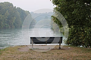 Empty bench by the river