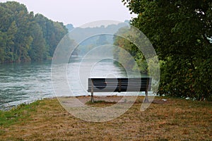 Empty bench by the river