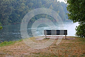 Empty bench by the river