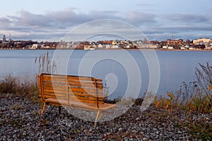 Empty bench by the river