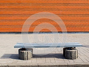 Empty bench in the street outside. Urban background. Rest and relaxation