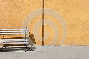 Empty bench in the street outside. Urban background. Rest and relaxation