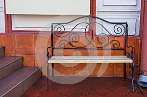 Empty bench in the street outside. Urban background. Rest and relaxation