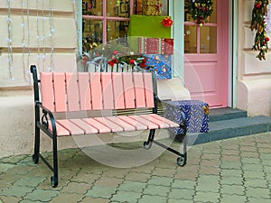 Empty bench in the street outside. Urban background. Rest and relaxation