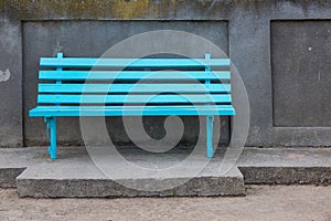 Empty bench in the street outside. Urban background. Rest and relaxation