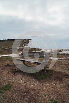 Empty bench on the top of chalk cliffs at Seaford Head. Seven Sisters, South of England