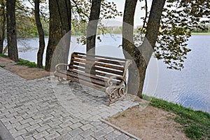 Empty bench by the water