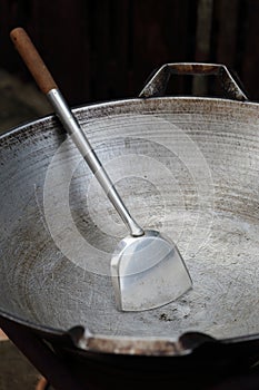 Empty big pan and scoop or flipper used in frying