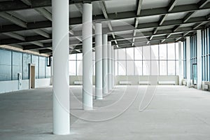 Empty big room with white columns and big windows