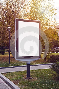 Empty billboard, advertising placeholder in a Moscow autumn park, mockup of a blank white poster.